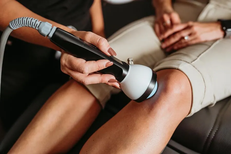 A StemWave acoustic wave device applied to a patient's knee during treatment